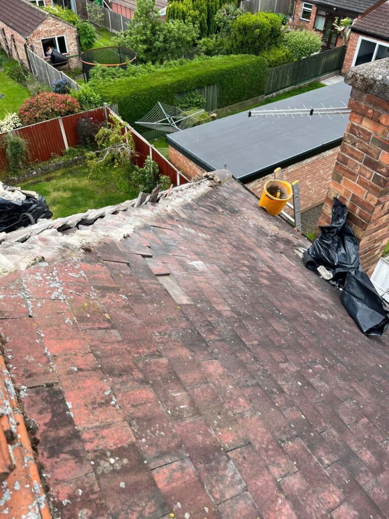 This is a photo of a roof where the hip tiles have been removed, and are just about to be replaced. Works carried out by Long Eaton Roofing Repairs